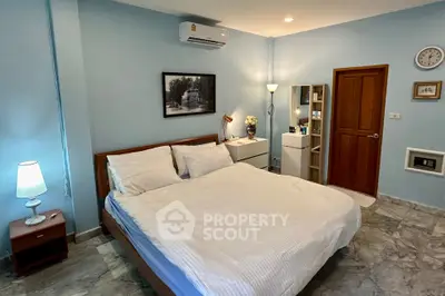 Cozy bedroom with modern decor and soft lighting, featuring a comfortable bed and stylish furnishings.