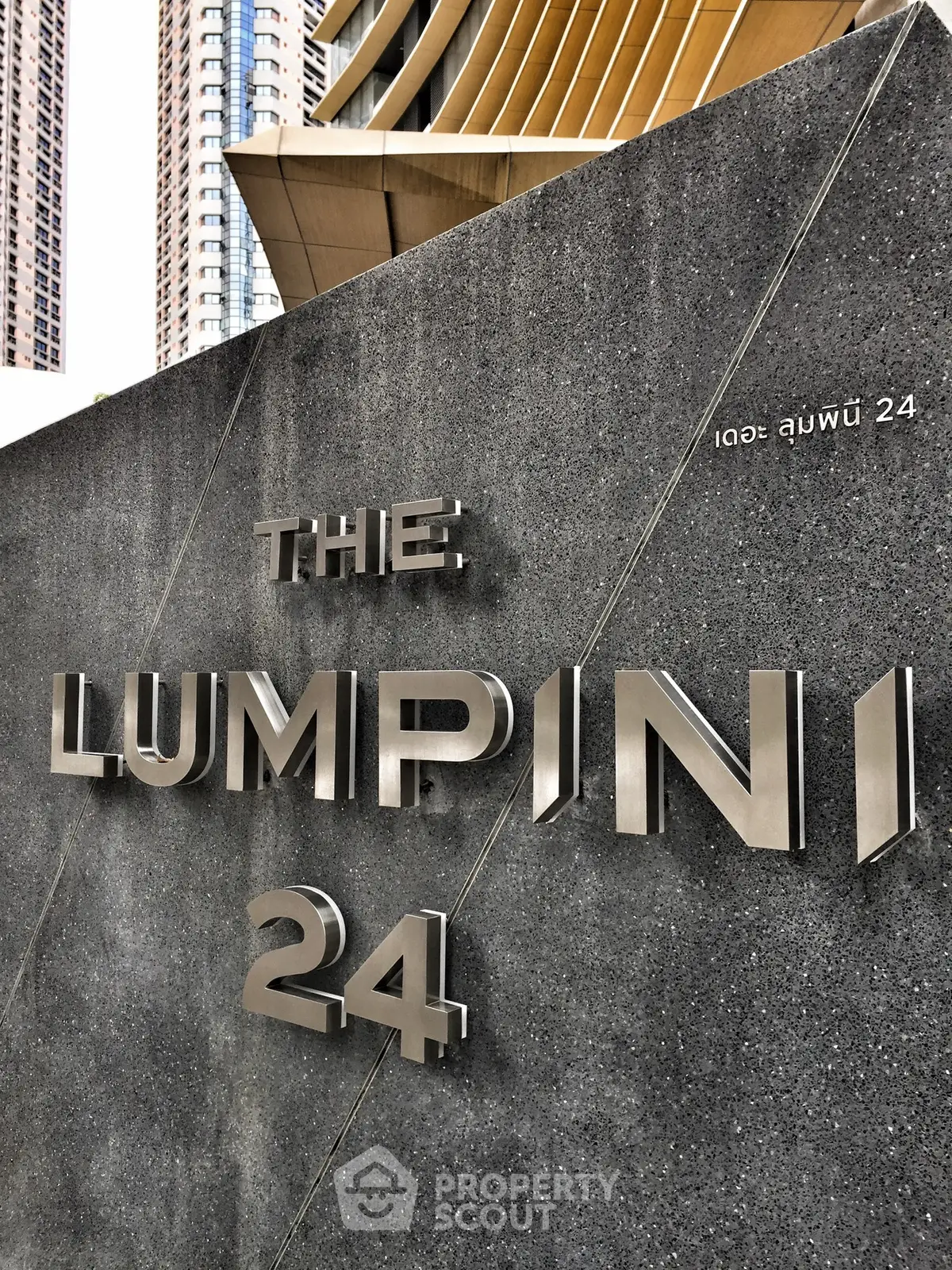 Modern exterior of The Lumpini 24 building with sleek architectural design.