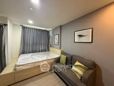 Modern bedroom with stylish decor and cozy sofa, perfect for relaxation.