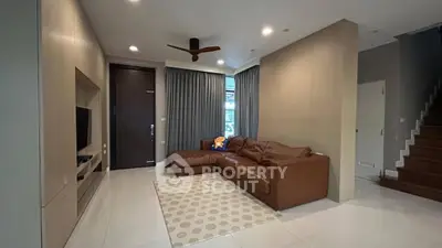 Spacious living room with modern decor and cozy leather sofa
