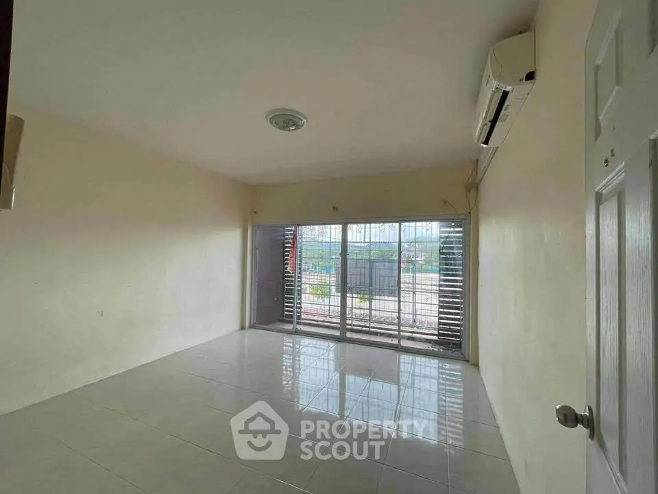 Spacious unfurnished living room with large windows and air conditioning