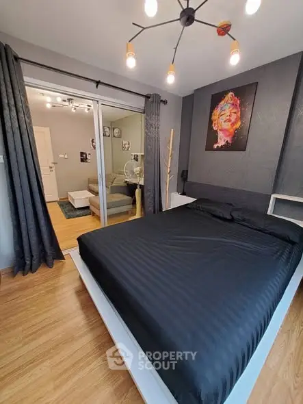 Modern bedroom with stylish decor and wooden flooring