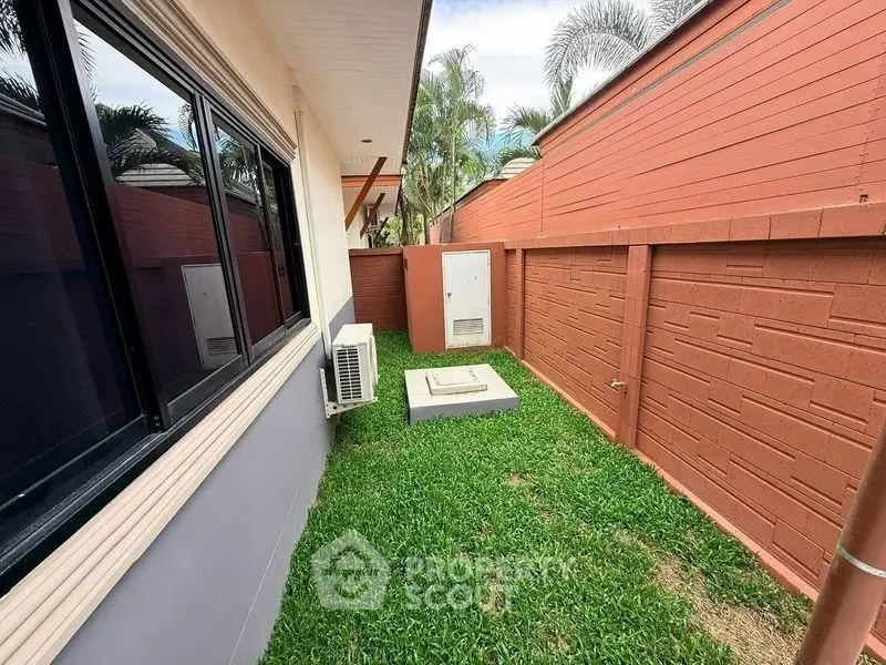 Charming backyard with lush grass and privacy fence, perfect for relaxation and outdoor activities.