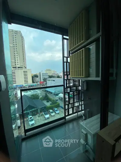 Modern balcony with city view and laundry area in urban apartment