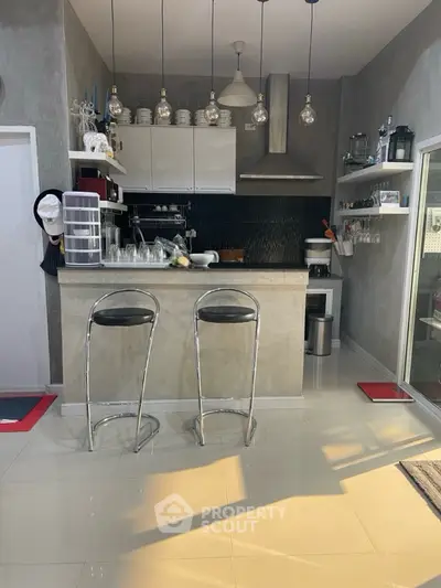 Modern kitchen with sleek bar stools and stylish lighting