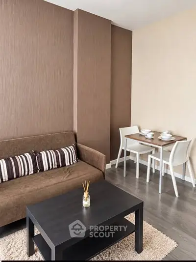 Modern living room with cozy brown sofa and dining area, perfect for urban living.