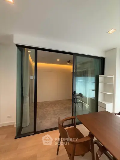 Modern interior with sliding glass doors and elegant wooden furniture in a stylish living space.
