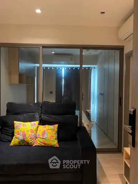 Modern living room with sleek design and vibrant cushions