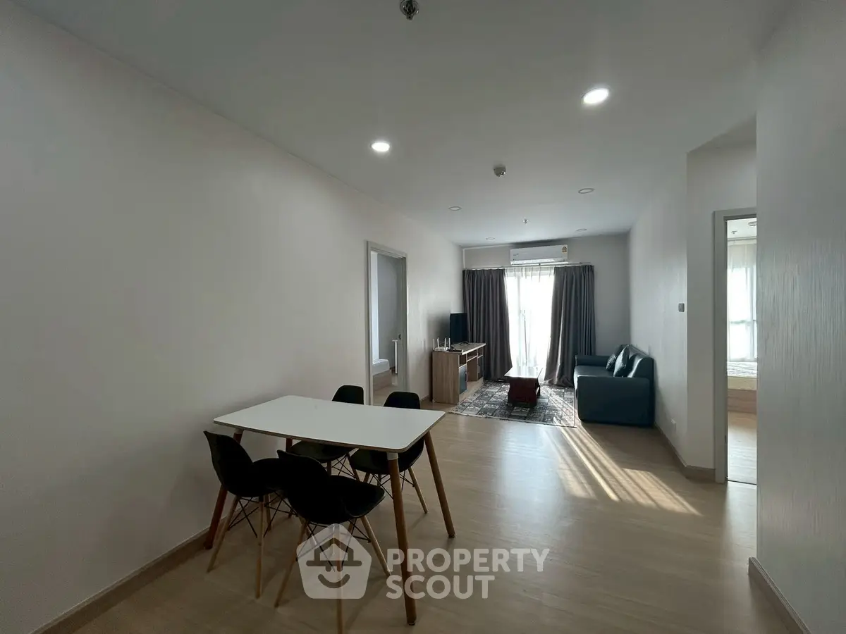 Modern open-plan living and dining area with natural light and stylish furnishings.