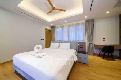 Luxurious bedroom with modern decor and elegant lighting, featuring a cozy bed and stylish furnishings.