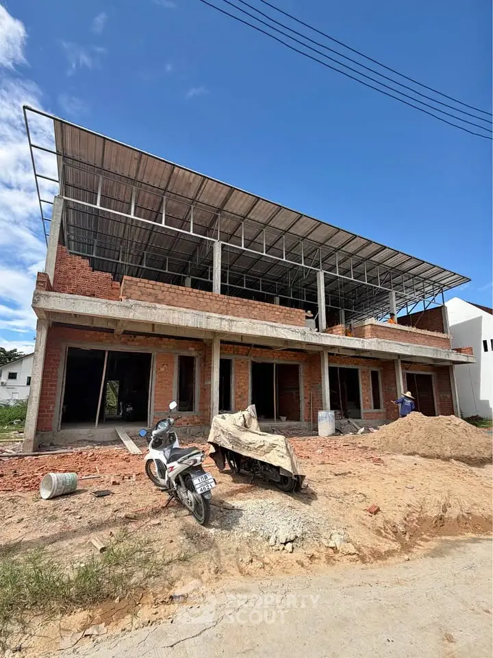 Under-construction commercial building with modern design and spacious layout, ideal for investment opportunities.