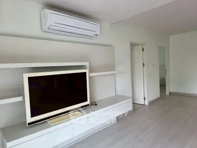 Modern living room with sleek TV unit and air conditioning