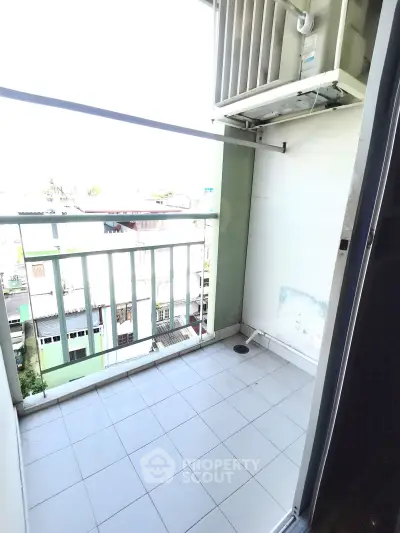 Charming balcony with city view, perfect for relaxation and enjoying fresh air in urban setting.