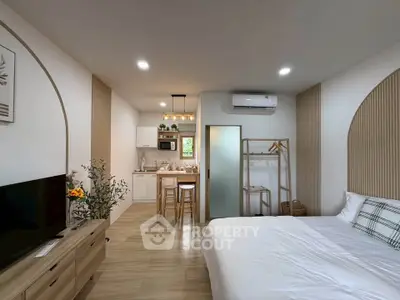 Modern studio apartment with cozy bedroom and open kitchen layout