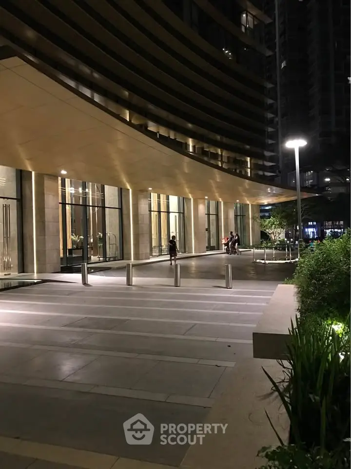 Elegant building entrance with modern lighting and sleek architectural design, perfect for luxury urban living.