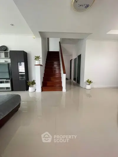 Spacious modern living room with sleek staircase and elegant decor