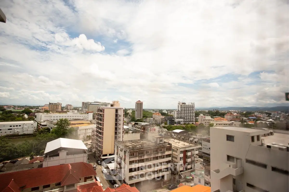 Stunning cityscape view from high-rise building showcasing urban skyline and expansive sky.