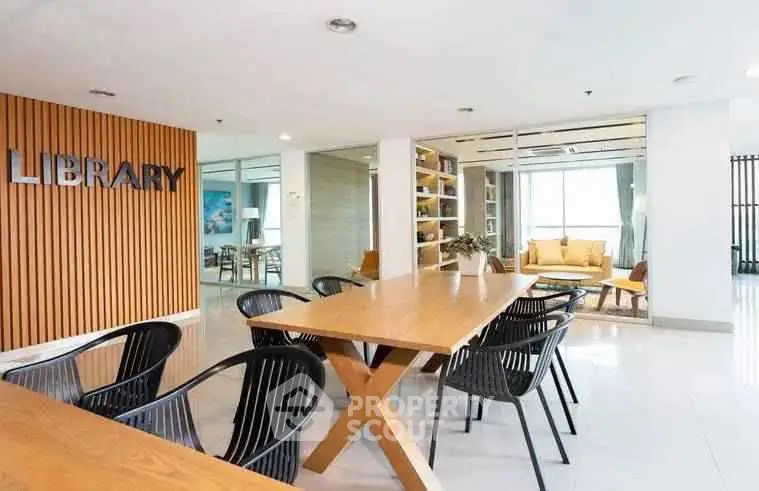 Modern library space with stylish seating and wooden accents in a contemporary building.