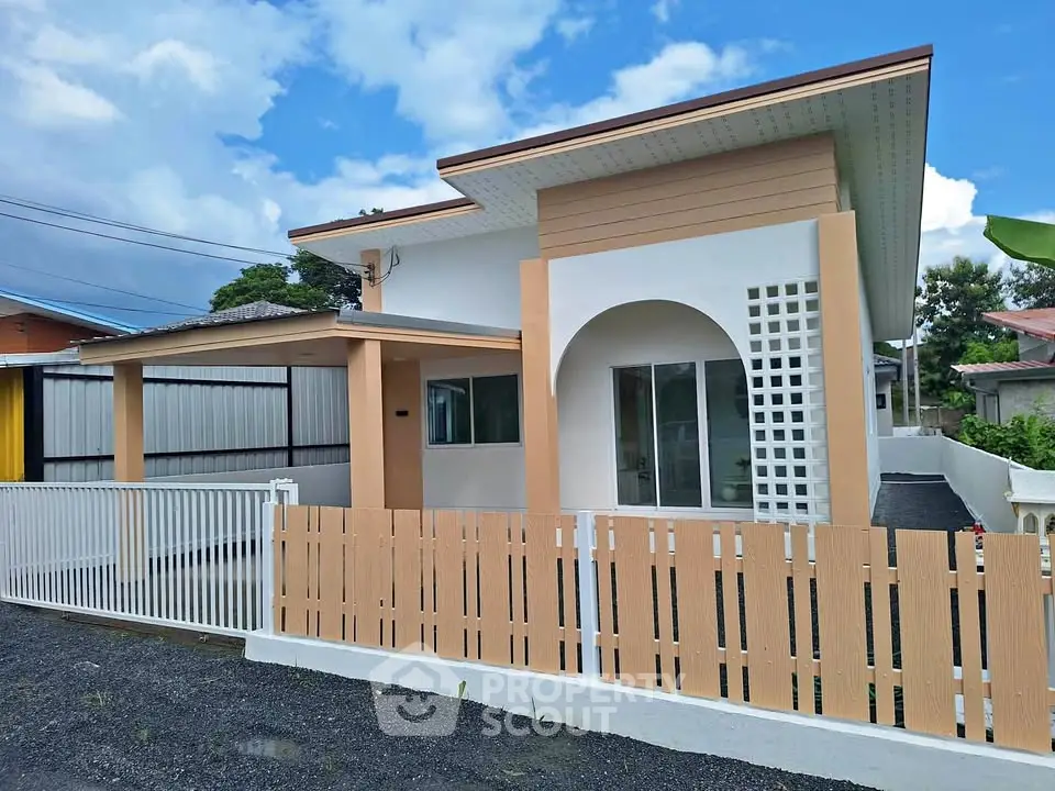 Modern single-story house with stylish facade and fenced yard, perfect for family living.