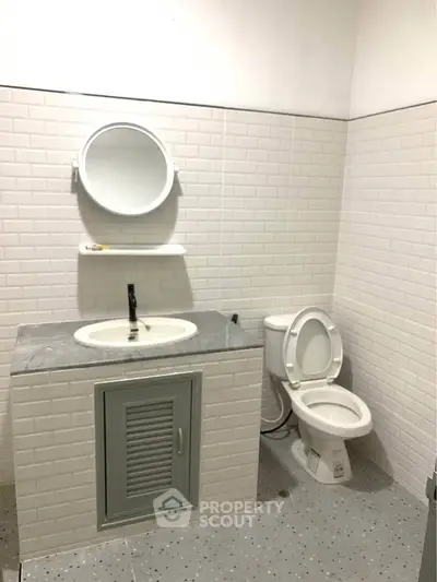 Modern bathroom with white subway tiles and sleek fixtures