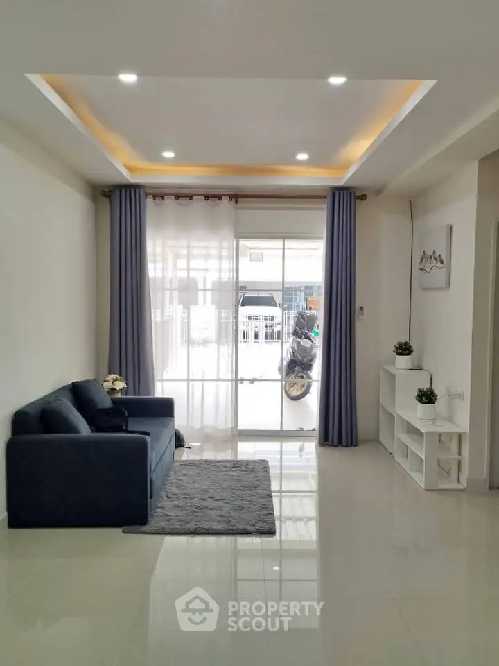 Modern living room with sleek design and large windows for natural light.