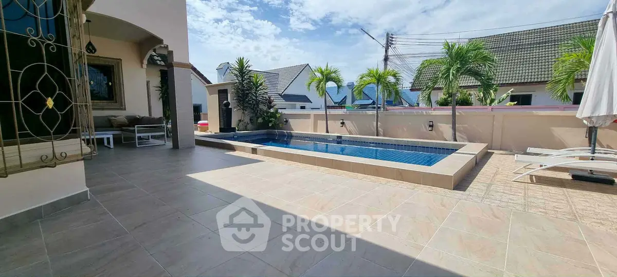 Luxurious outdoor pool area with modern design and palm trees, perfect for relaxation and entertainment.