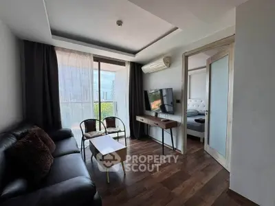 Modern living room with balcony view, sleek furniture, and natural light.