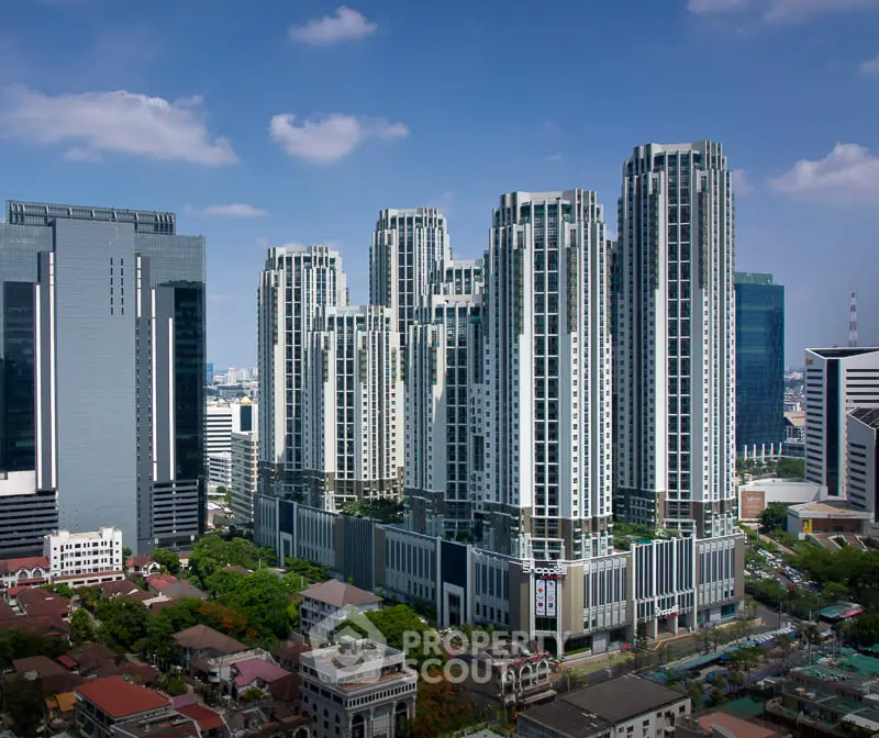 Stunning cityscape view of modern high-rise buildings under a clear blue sky.