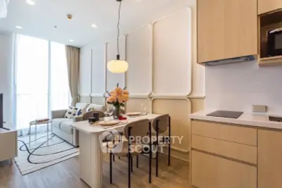 Modern open-plan living room and kitchen with elegant decor and natural light.