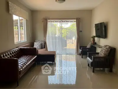 Spacious living room with modern furniture and large windows offering natural light.