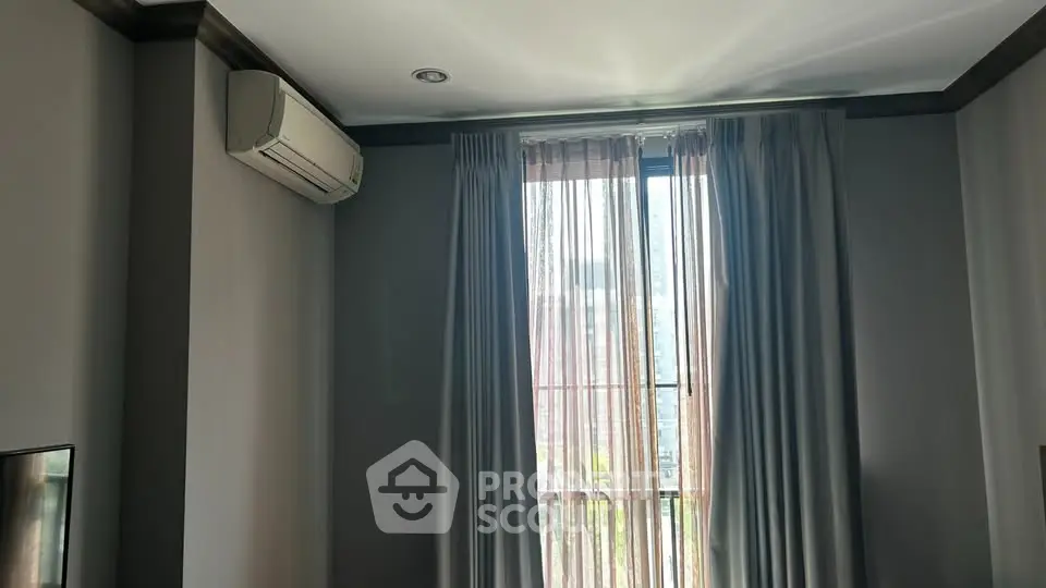 Modern room with air conditioning and large window with curtains