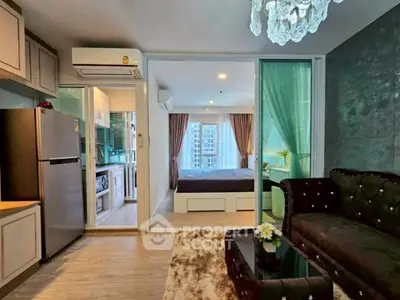Modern apartment interior with open living room and kitchen, featuring elegant decor and city view.