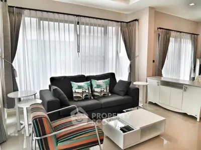 Stylish modern living room with large windows and elegant furniture