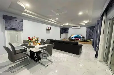 Spacious modern living room with elegant dining area and sleek furnishings