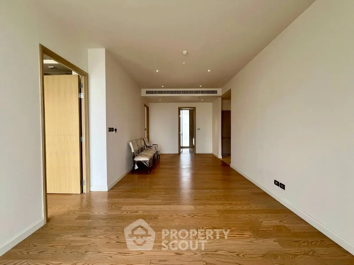 Spacious empty living room with wooden flooring and modern design
