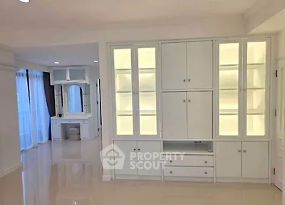 Elegant interior with built-in cabinets and bright lighting in a modern living space.
