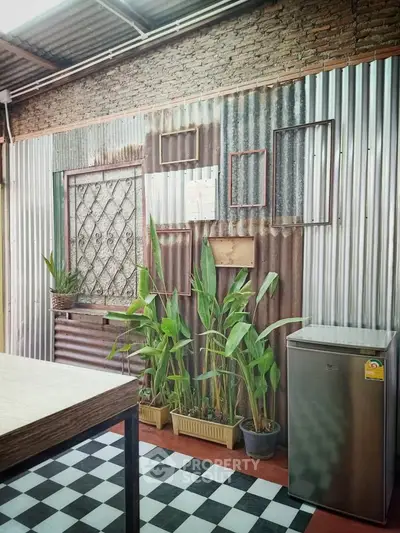 Charming rustic kitchen with corrugated metal walls and potted plants
