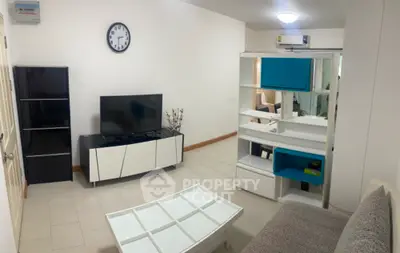 Modern living room with stylish furniture and wall clock