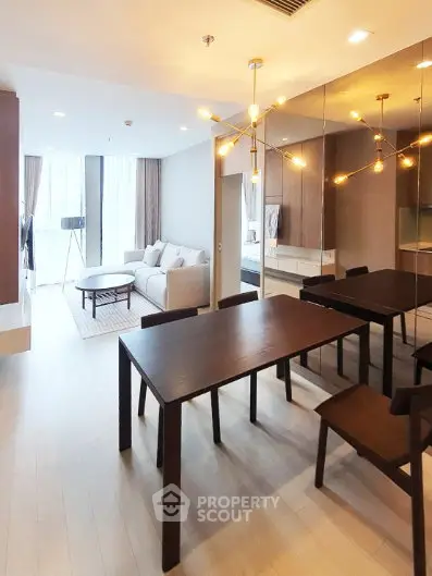 Modern living room with elegant dining area and stylish lighting in a contemporary apartment.