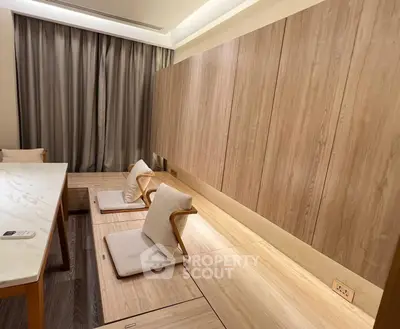 Modern minimalist living room with wooden paneling and cozy seating area.