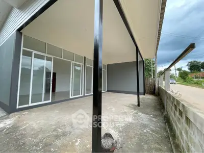 Spacious modern property with large open patio and sleek glass doors, perfect for versatile outdoor living.