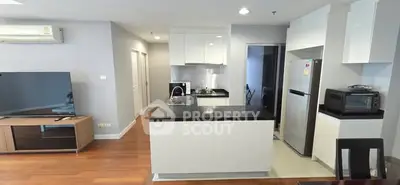 Modern kitchen with sleek appliances and open layout in stylish apartment.