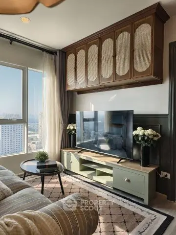 Stylish living room with modern decor and city view, featuring a large TV and elegant furnishings.