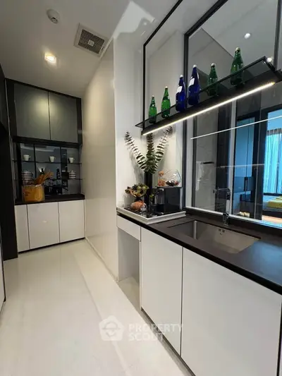 Modern kitchen with sleek design and open layout, featuring stylish cabinetry and elegant decor.