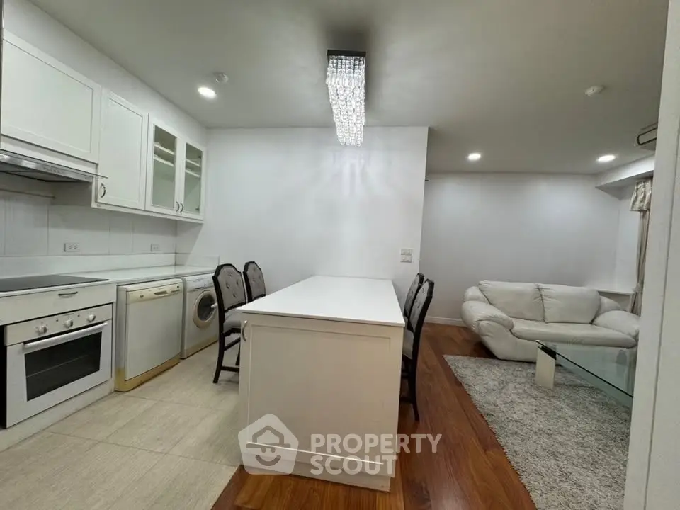 Modern open-layout kitchen with sleek appliances and cozy living area, perfect for entertaining.