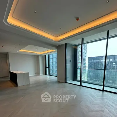 Spacious modern living room with floor-to-ceiling windows and city view.