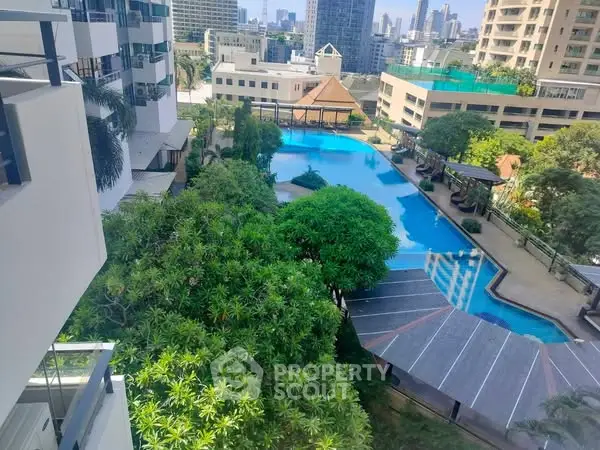 Luxurious urban apartment with stunning pool and lush greenery view.