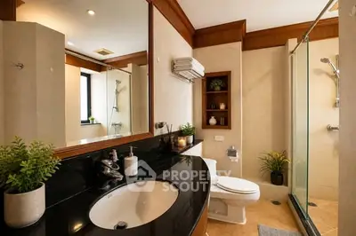 Luxurious bathroom with elegant fixtures and spacious shower area