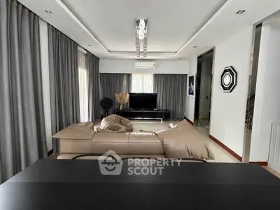 Modern living room with sleek design, featuring a leather sofa and stylish decor, perfect for contemporary living.