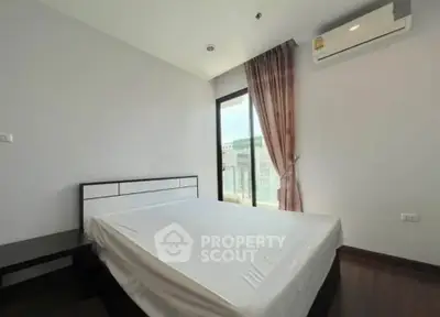 Modern bedroom with large window and air conditioning in a high-rise apartment.
